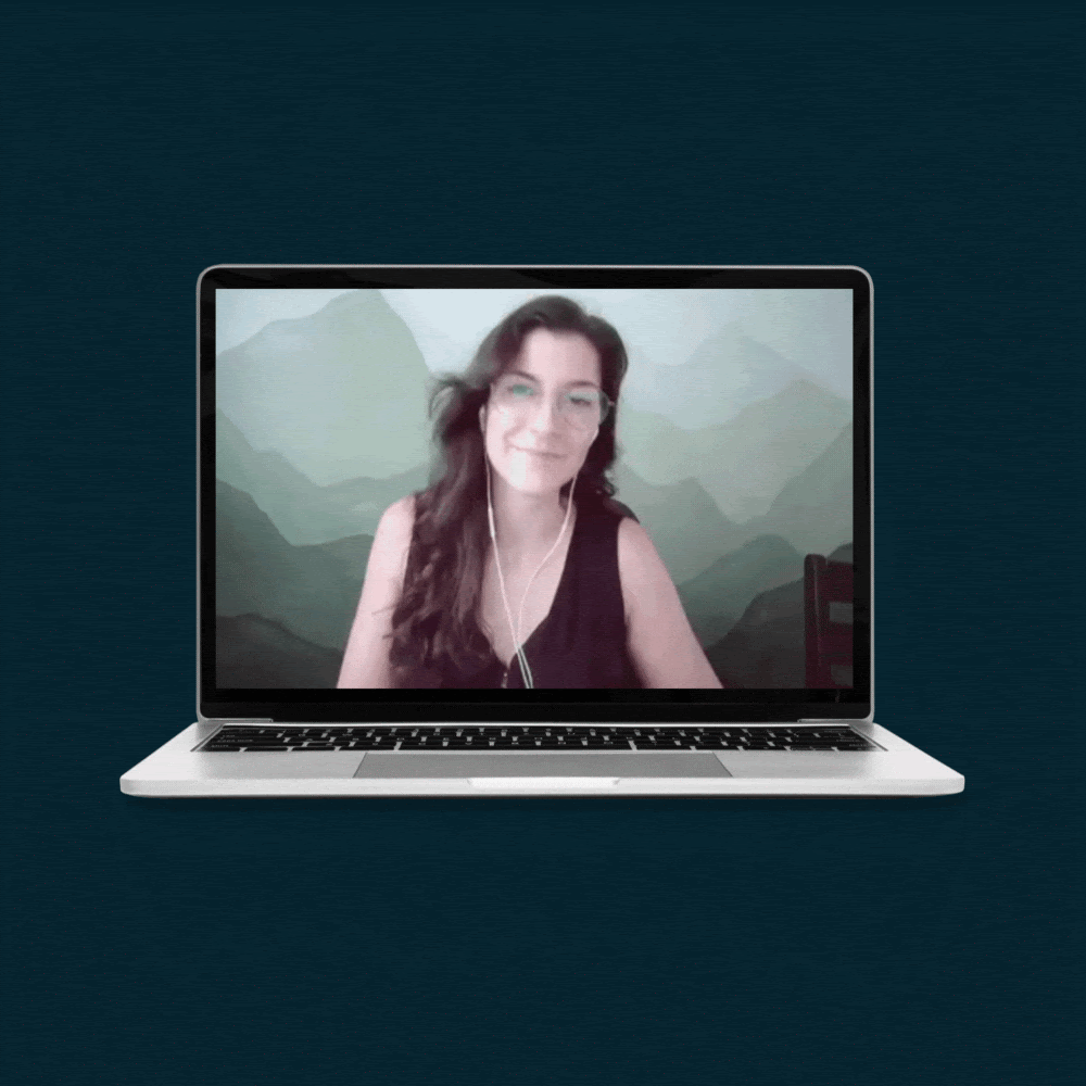 Gif of a laptop showing Caitlin, waiving at the screen and giving a thumbs up.